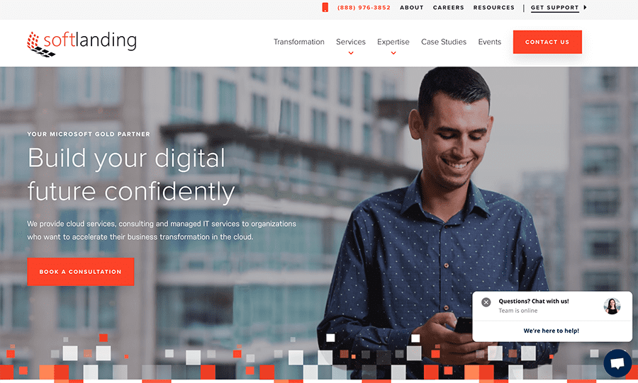 screenshot of Soft Landing's homepage with a photo of a man using a smartphone with a city landscape behind him