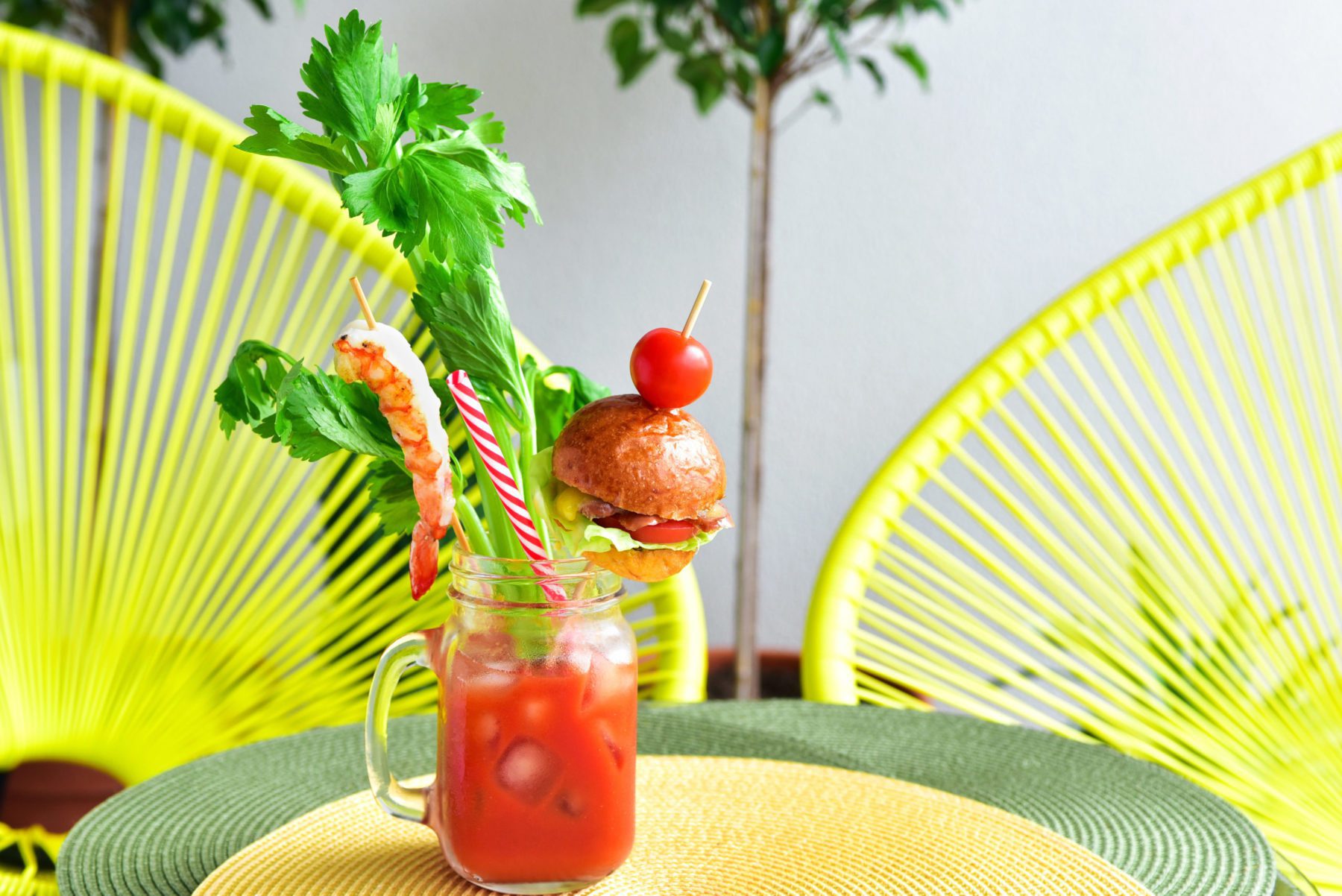 photo of a bloody mary cocktail with a tiny hamburger on top
