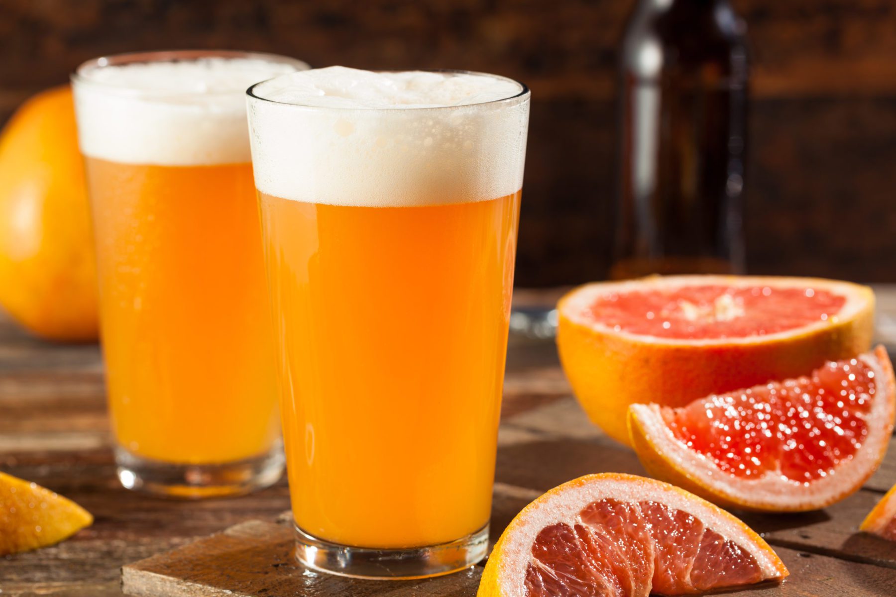 photo of two pints of sour ale next to a sliced grapefruit
