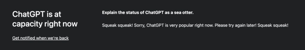 Screenshot showing the familiar ChatGPT screen for when the server is too busy. It entertains the disappointed user by prompting ChatGPT to write a joke. This one says "Explain the status of Chat GTP as a sea otter." The response is "Squeak squeak! Sorry, ChatGPT is very popular right now. Please try again later! Squeak squeak!"